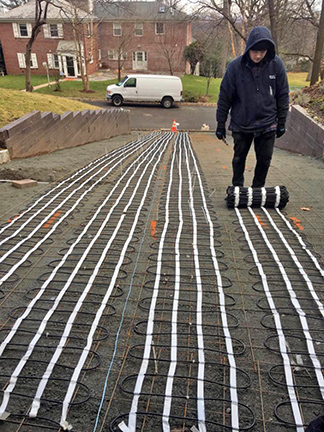 A radiant heated paver walkway being installed.