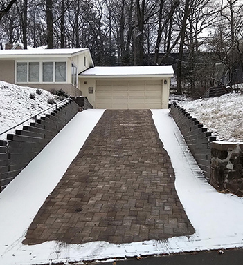 Radiant heated snow melting system heating a paver driveway.